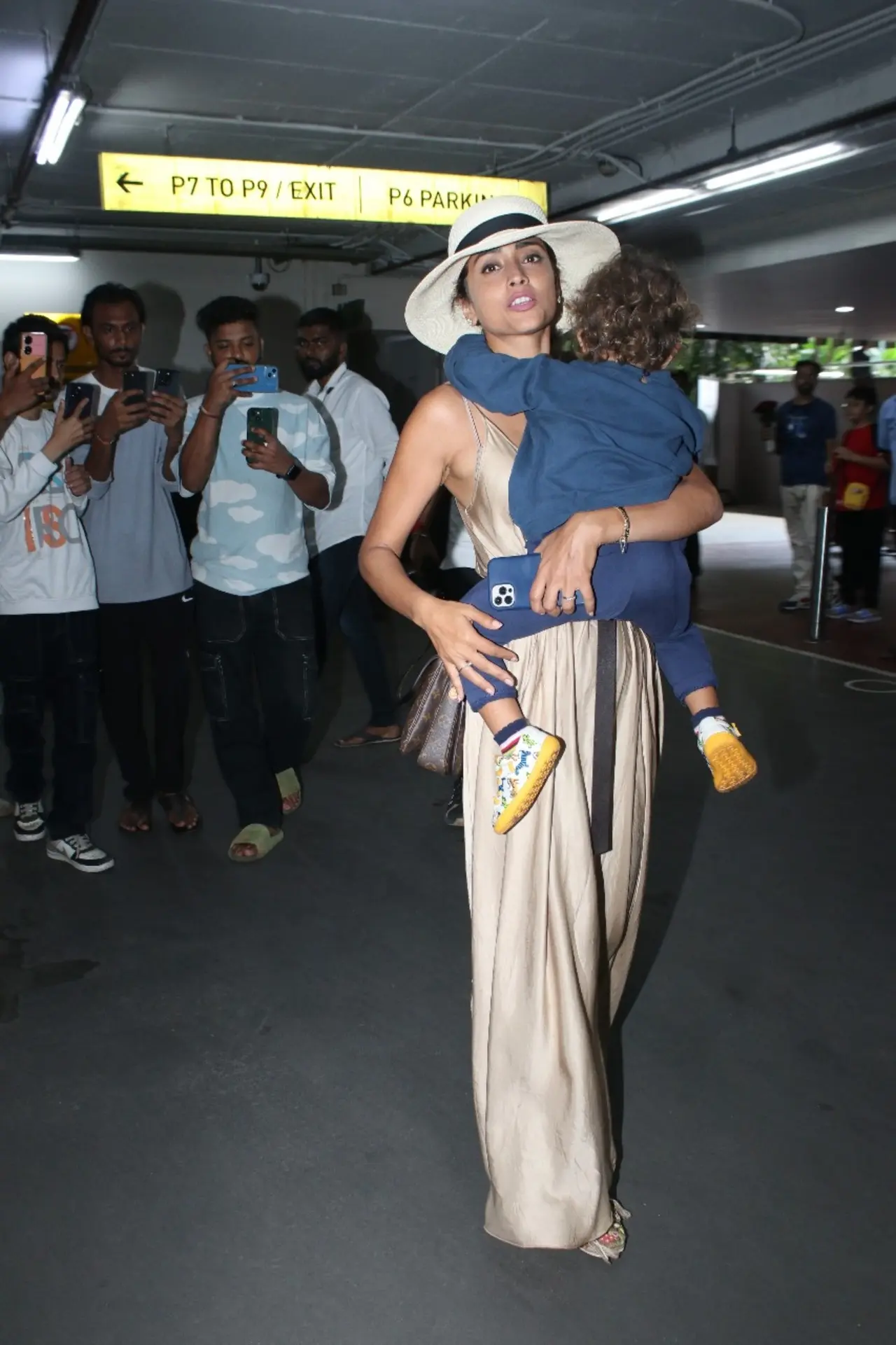 Shriya Saran clicked at the airport wearing a cool beige gown with a beach hat